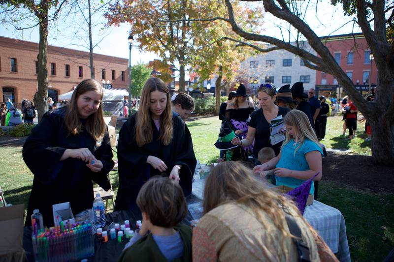 Kids and parents line up to make witches brew at the Witches and Wizards of Woodstock on Sunday, Oct. 20,2024 in Woodstock.