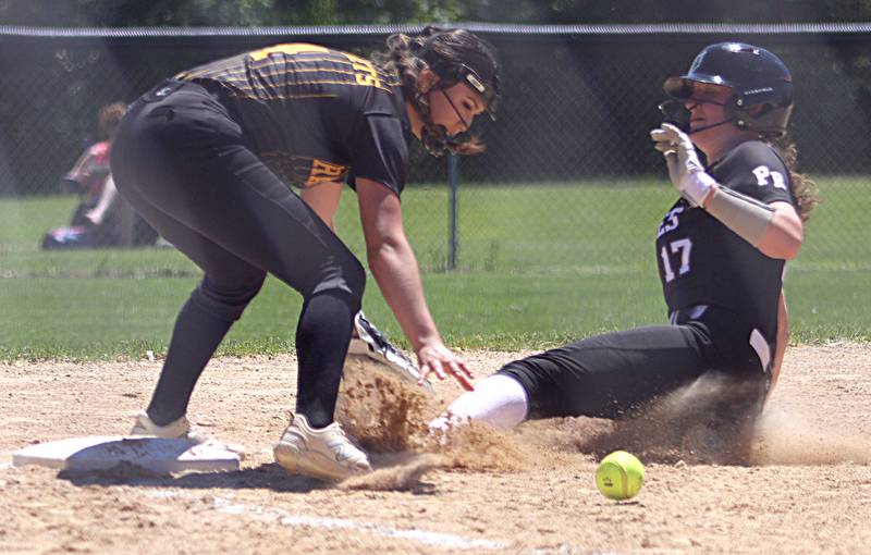 Prairie Ridge’s Parker Frey, right, slides safely into third base as Harvard’s Ytzel Lopez fields the throw during Class 3A softball regional final action at Lions Park in Harvard Saturday.