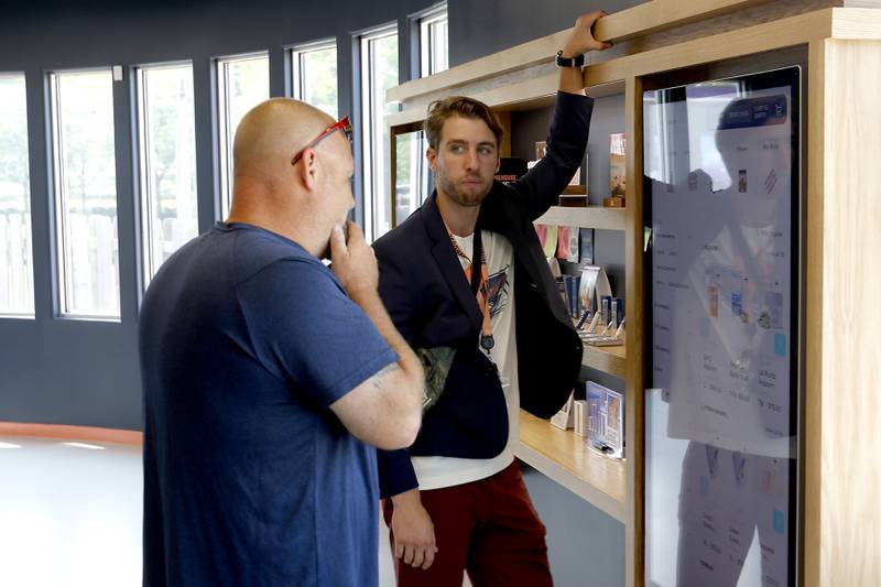 Smokehouse General Manager Zach Edgerton helps a customer at Illinois’ first dispensary located right on the water in Fox Lake on Friday, July 25,2024. The dispensary located at 44 U.S. Route 12, features boat slips so customers on the Fox River Chain of Lakes can boat right up to the dispensary.