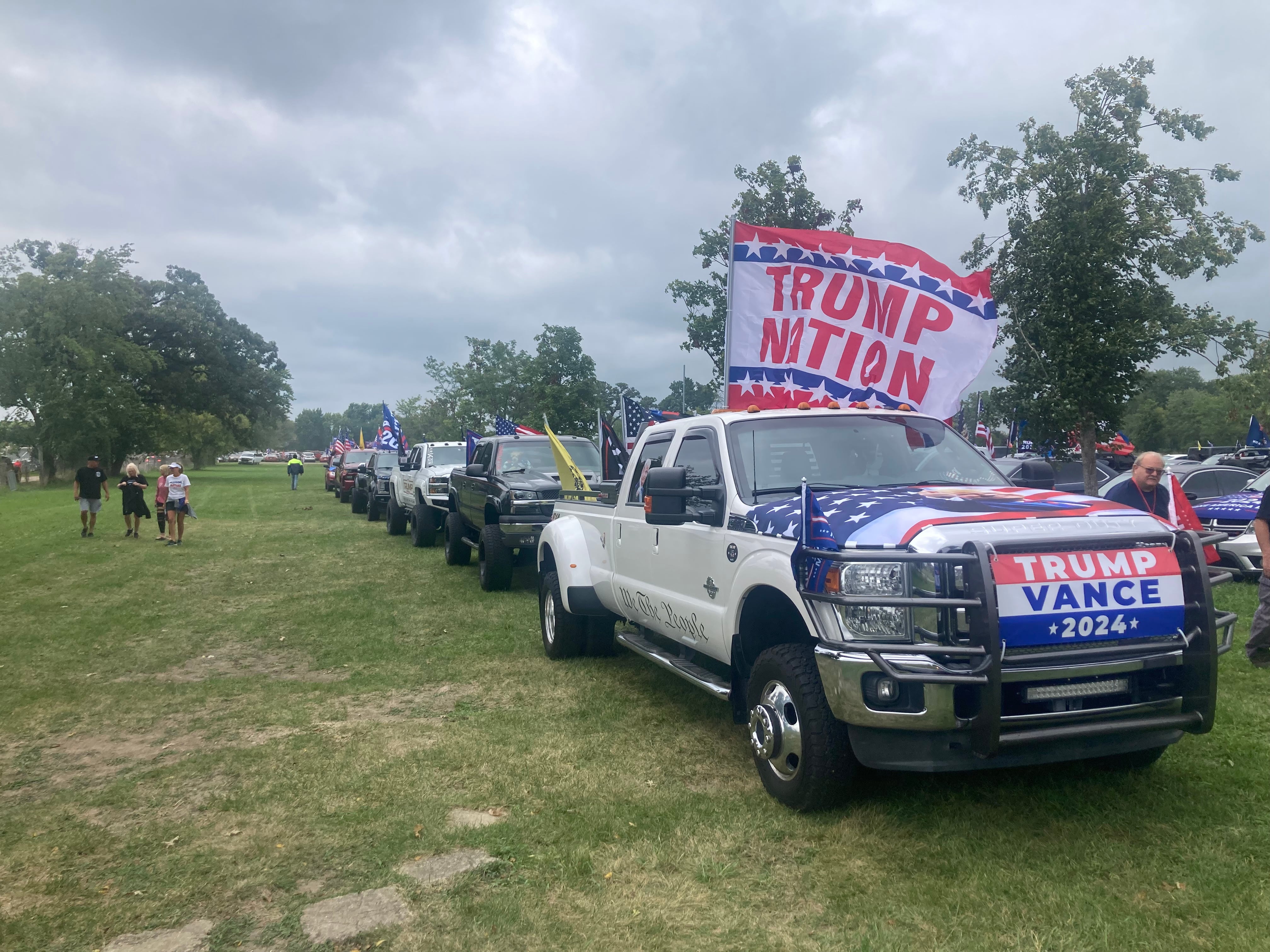 Vehicle decorated with pro-Trump signs arrive at the McHenry County Fairgrounds for a Republican rally on Aug. 18, 2024.