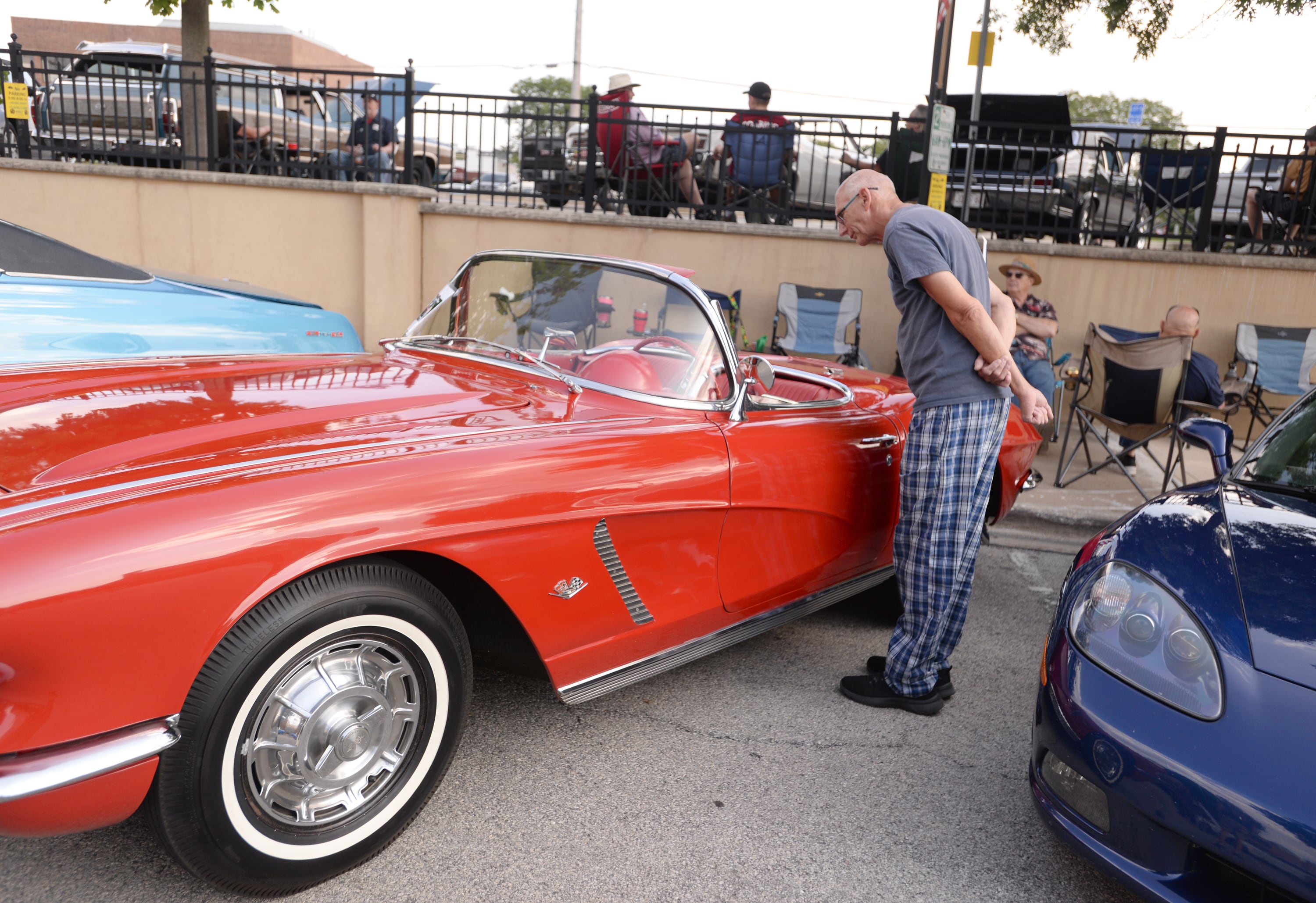 Jim Pinc of Downers Grove checks out a 1962 Corvette during the Downers Grove Car Show Friday July 19, 2024.