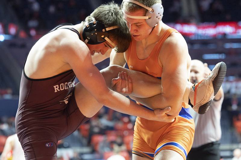 Genoa-Kingston’s Brady Brewick grabs the leg of Rockridge’s Ryan Lower in the 165 pound 1A third place match Saturday, Feb. 17, 2024 at the IHSA state wrestling finals at the State Farm Center in Champaign.