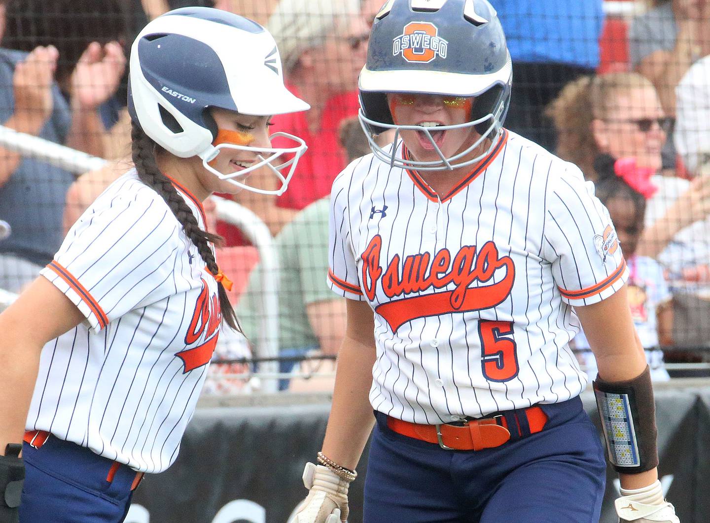 Oswego's Rhiana Martinez and Marissa Moffett react after scoring a run against Mundelein during the Class 4A third place game on Saturday, June 8, 2024 at the Louisville Slugger Sports Complex in Peoria.