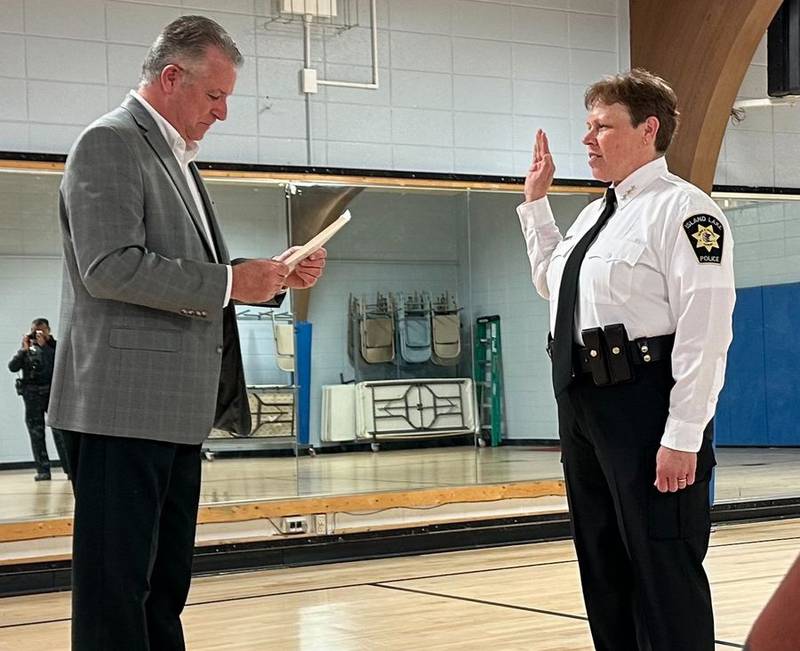 Island Lake Mayor Richard McLaughlin swears in Jennifer Paulus as the new police chief.