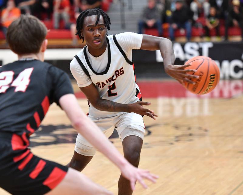 Bolingbrook's DJ Strong  makes a backhand pass in front of Benet's Daniel Pauliukonis (24) during a Class 4A East Aurora Sectional semifinal game on Feb. 27, 2024 at East Aurora High School in Aurora.