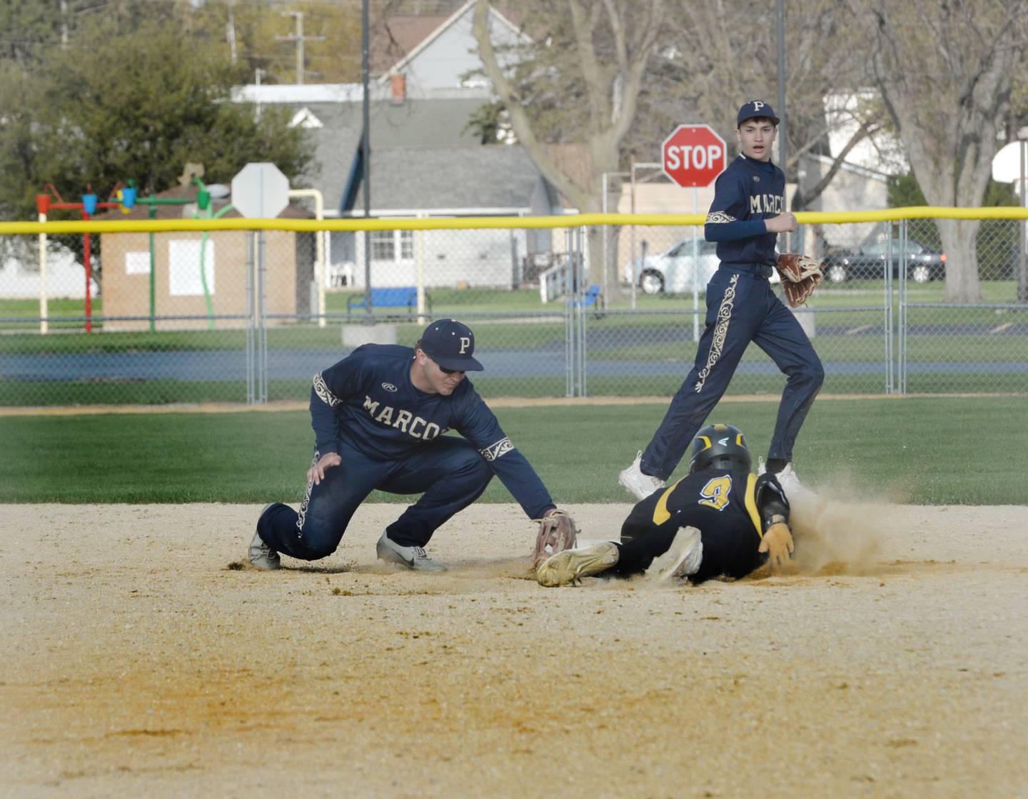 Polo's Brady Wolber tags out AFC's Logan O'Brien in an attempted steal during a Tuesday, April 25 game in Ashton.