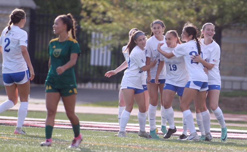 St. Charles North players celebrate Laney Stark’s goal during the Class 3A state semifinal game against Fremd at North Central College in Naperville on Friday, May 31, 2024.