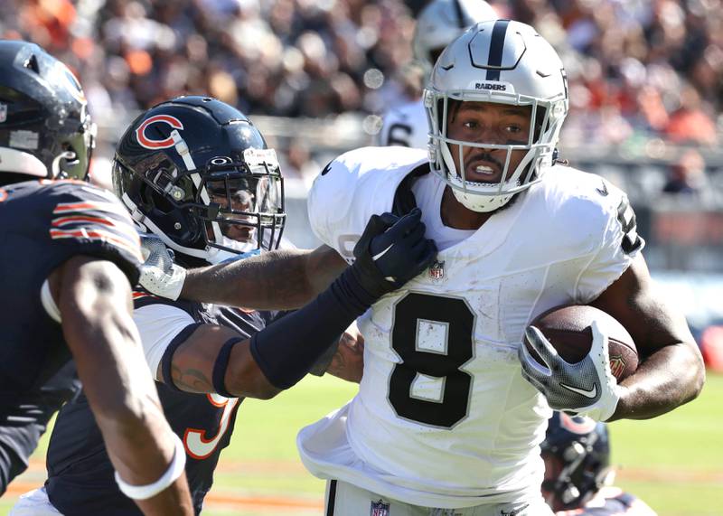 Chicago Bears safety Jaquan Brisker brings down Las Vegas Raiders running back Josh Jacobs during their game Sunday, Oct. 22, 2023, at Soldier Field in Chicago.