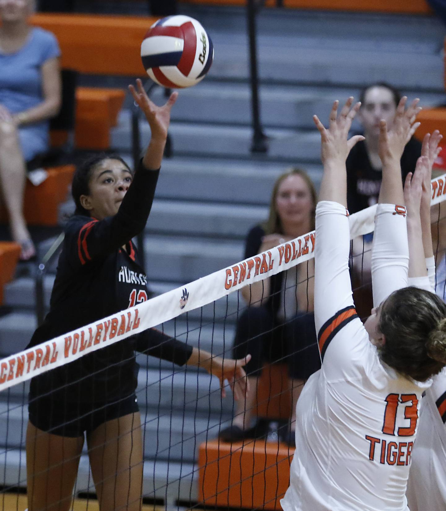 Huntley’s Morgan Jones spikes the ball as Crystal Lake Central’s Siena Smiejek tries to block the ball during a Fox Valley Conference volleyball match Tuesday, Aug. 23, 2022, between Crystal Lake Central and Huntley at Crystal Lake Central High School.