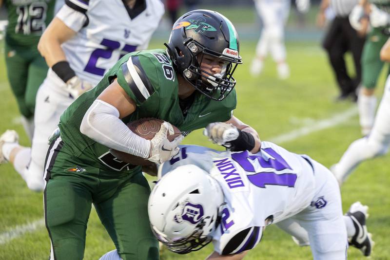 Rock Falls’ Korbin Oligney fights for yards against Dixon’s Gabe Rowley Friday, Sept. 13, 2024, at Hinders Field in Rock Falls.