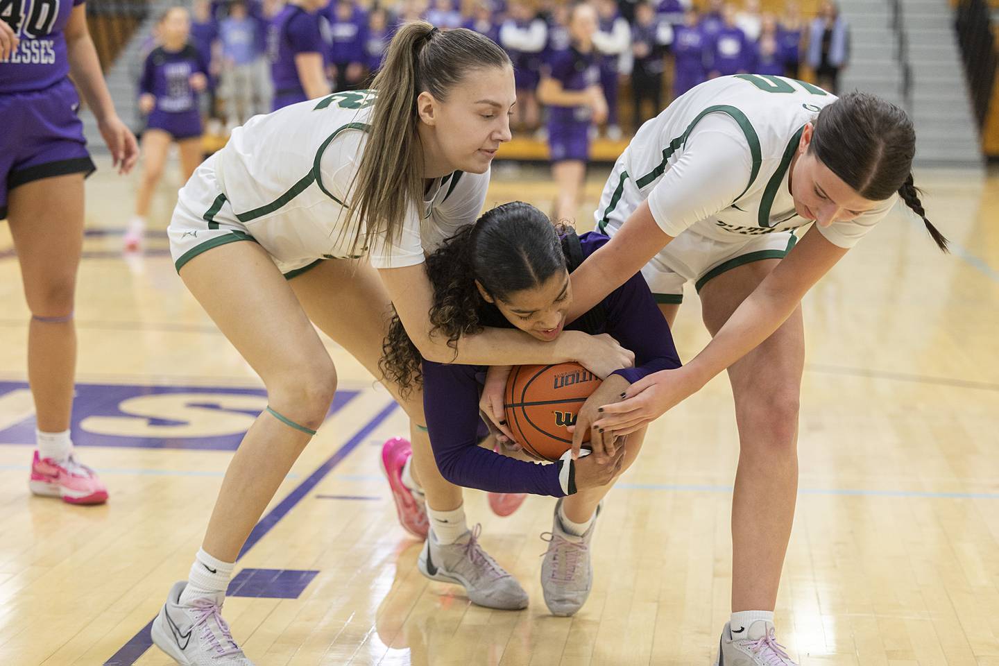 Dixon’s Ahmyrie McGowan and Boylan’s Lily Esparza (left) and Gianna Marinaro fight for a ball Friday, Feb. 16, 2024 at the class 3A Rochelle girls basketball regional.