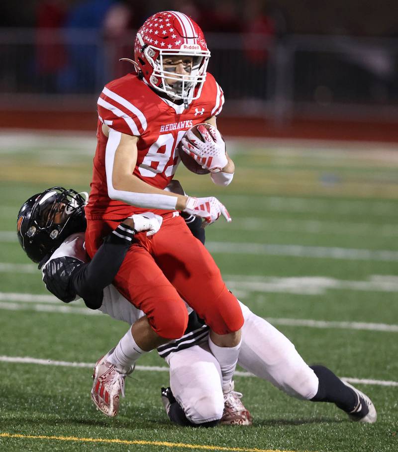 Naperville Central’s Alex Liabo tries to pull away from a DeKalb defender during their game Friday, Oct. 6, 2023, at Naperville Central High School.