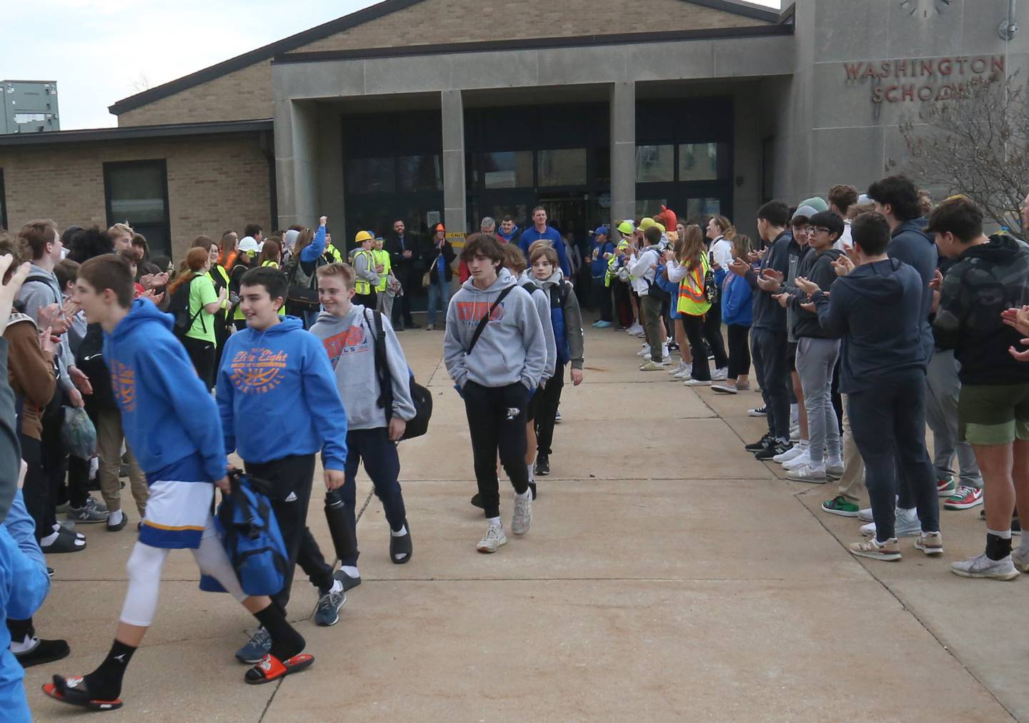 Members of the Oglesby Washington 7th grade basketball team exit the school to board a charter bus to attend the Illinois Elementary School Association Class 2A State championship on Thursday, Feb. 8, 2024 at Oglesby Washington School. Oglesby plays Effingham for the Class 2A State Title.