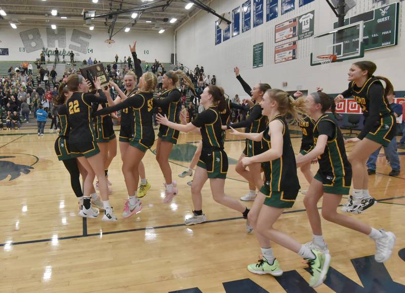 Fremd teammates dance with the Bartlett supersectional championship plaque on Monday, Feb. 26, 2024.