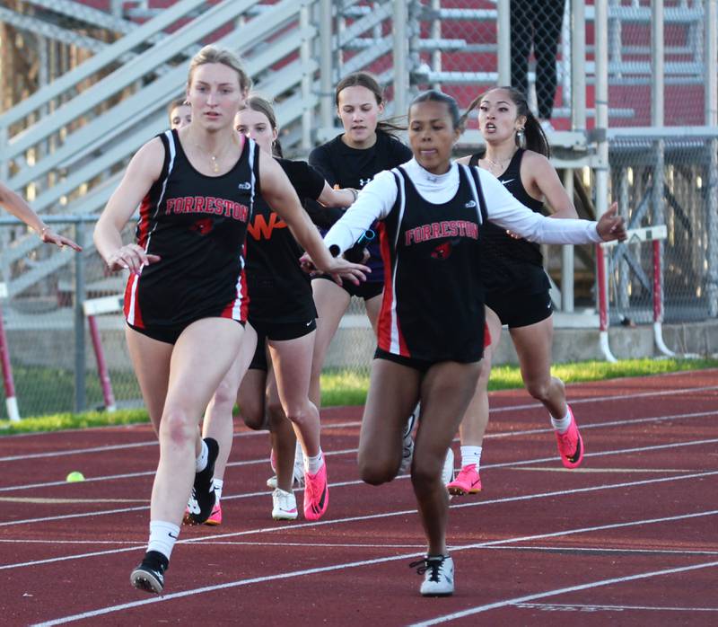 Forreston-Polo's Letrese Buisker hands the baton to anchor Autumn Pritchard in the 4x200 relay at the 1A Oregon Sectional on Friday. May 10, 2024. Forreston-Polo won the race in 1:49.13 to qualify for the state meet in Charleston.