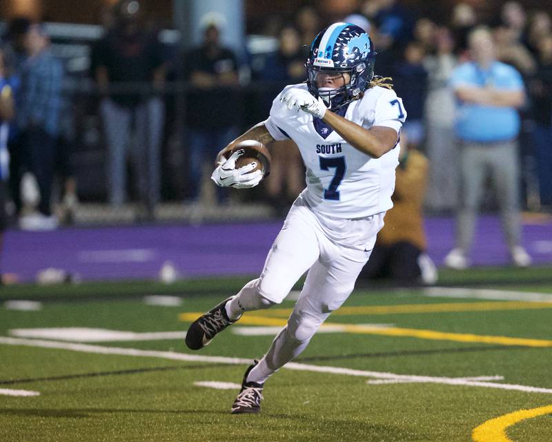 Downers Grove South's Keegan Garland carries the ball against Downers Grove North on Friday Sept. 6,2024 in Downers Grove.