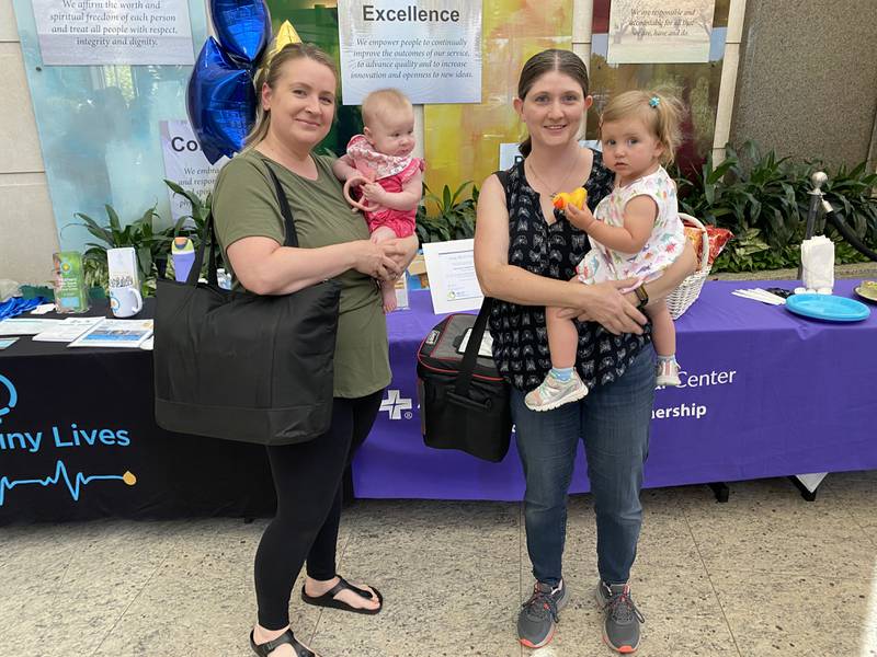 Jessica Neumeier (left) Allison Leist (right) with their coolers filled with frozen milk to donate. Neumeier, of Libertyville, donated 700 ounces of frozen excess milk during the milk depot’s grand opening event June 11.