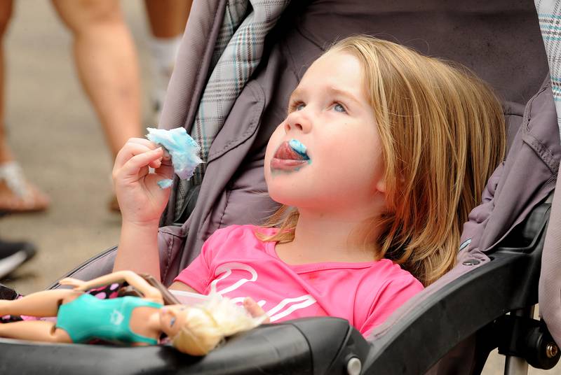 Four-year-old Kayla Morris of Yorkville enjoys her blue cotton candy during Riverfest on Hydraulic Avenue in Yorkville on Saturday, July 20, 2024.