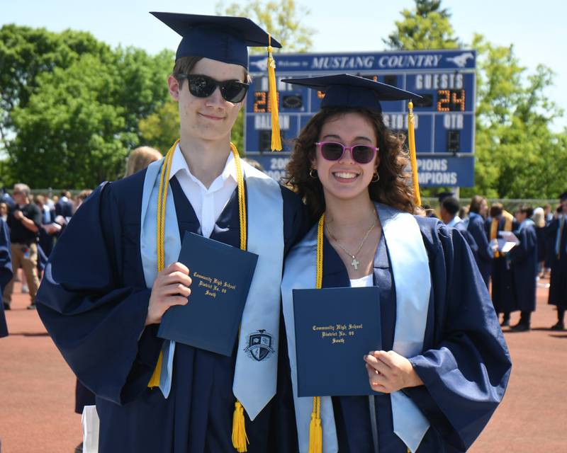 Nathan Bennema and Gisele Hengst pose for a photo with their diplomas after graduating from Downers Grove South High School on Sunday May 19, 2024, held at Downers Grove South High School.