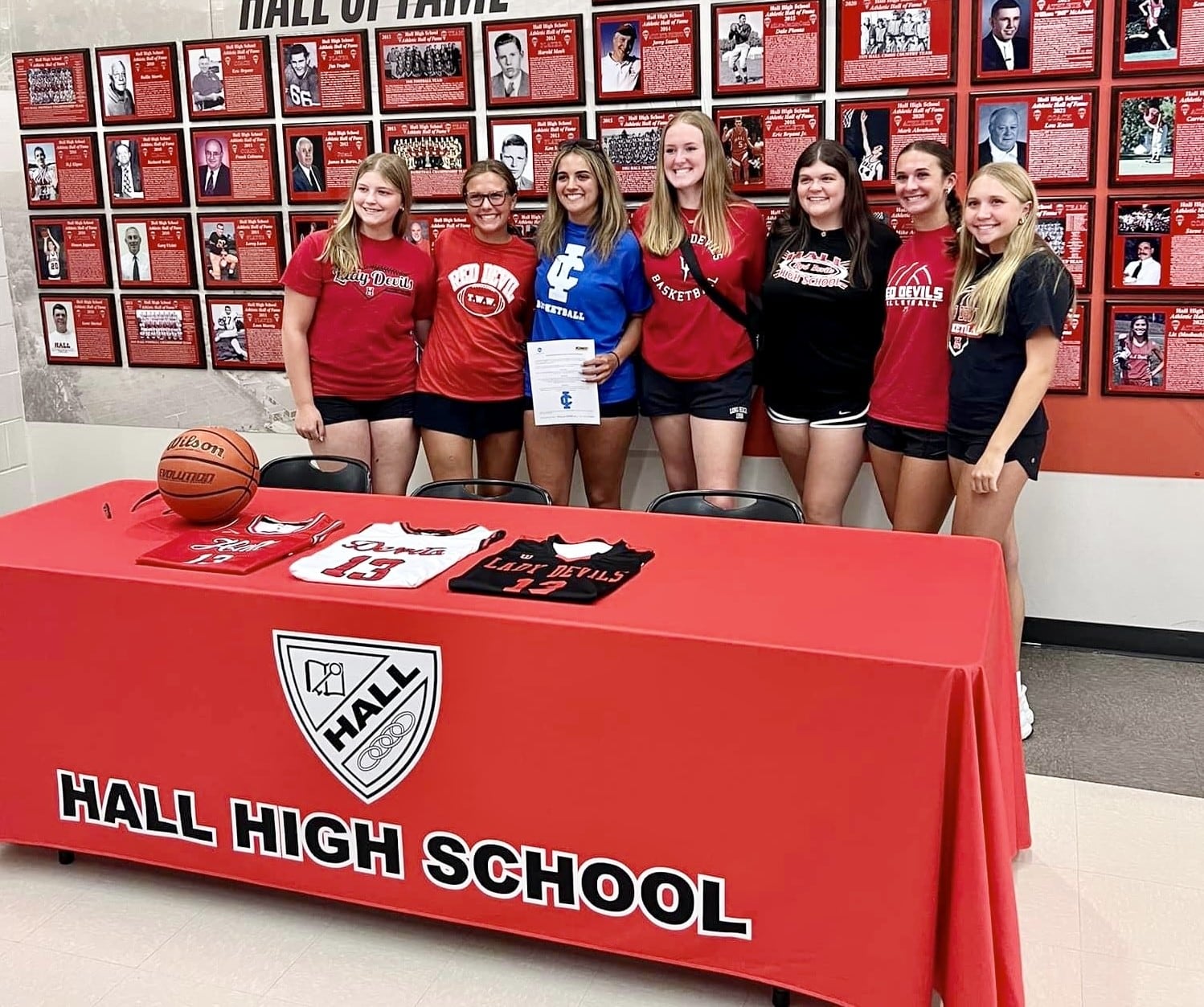 Recent Hall grad McKenna Christiansen (blue shirt) recently signed to play basketball for Illinois College, joined by several of her Hall teammates.