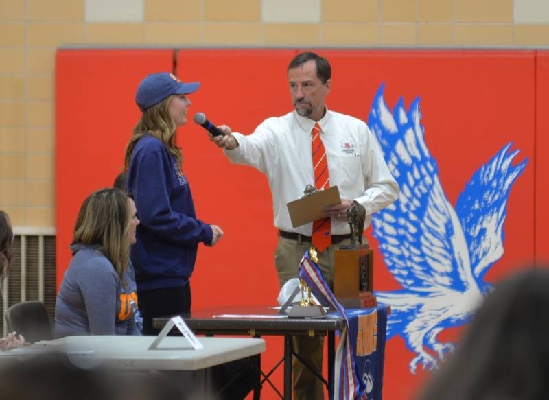 Oregon High School student Olivia Wynn talks to Athletic Director Mike Lawton during the school's Senior Class of 2023 College Athletics Recognition Event on May 3. Wynn will be competing in equestrian for the University of Tennessee-Martin.