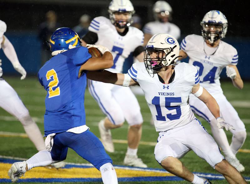 Geneva's Charlie Winterhalter (15) redirects Lake Forest's Nathan Williams (2) during the IHSA Class 6A playoff game Friday November 3, 2023 in Lake Forest.