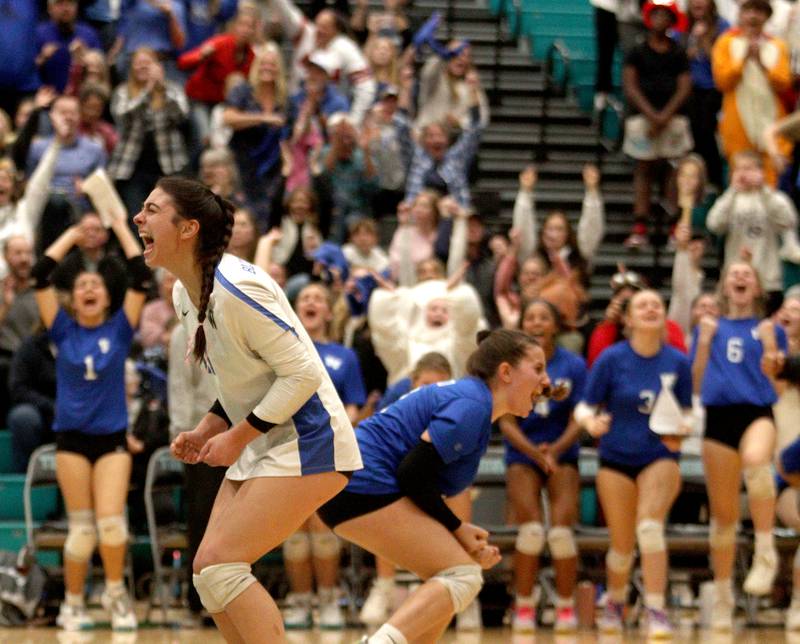 Woodstock’s Maia Garcia Carrasco, right, and Ella White, left, celebrate a point in IHSA Class 3A sectional semifinal volleyball action at Woodstock North Monday.