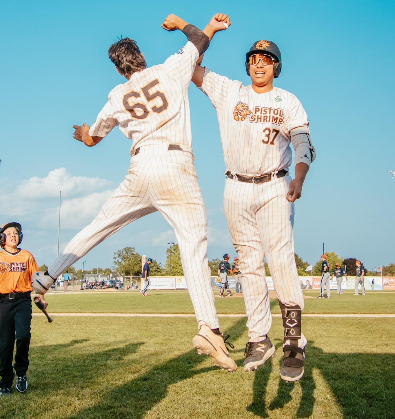 Kyle Gibson (65) and Pambos Nicoloudes celebrate during the Illinois Valley Pistol Shrimp's 9-8 victory over the Chillicothe Paints on Sunday, July 28, 2024 at Schweickert Stadium in Peru.