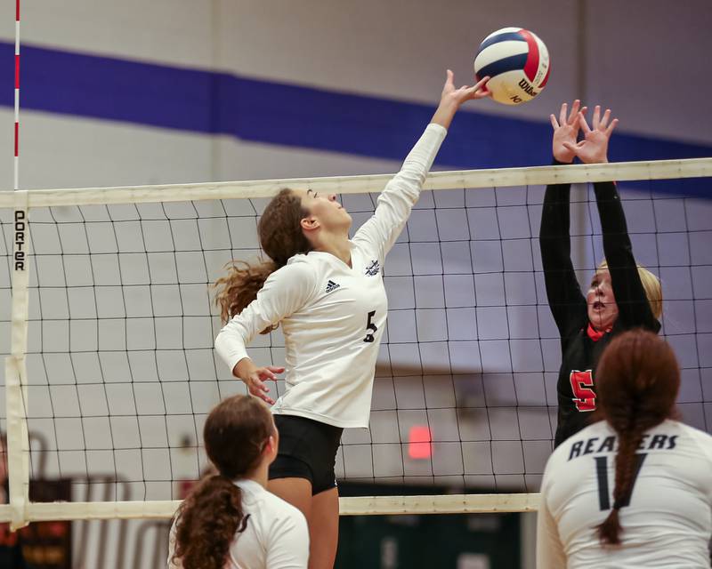 Plano's Alexa Sobieszczyk (5) tips the ball over the net during volleyball match between Sandwich at Plano.  August 21, 2023.