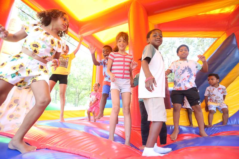 Kids play in a bounce house during the Juneteenth event on Wednesday June 19, 2024 at Kirby Park in Spring Valley.