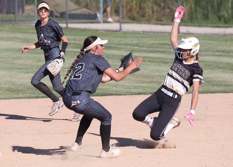 Sycamore's Faith Heil slides in with a stolen base as Kaneland's Angelina Campise awaits on the throw during their Class 3A sectional semifinal Thursday, May 30, 2024, at Sycamore High School.