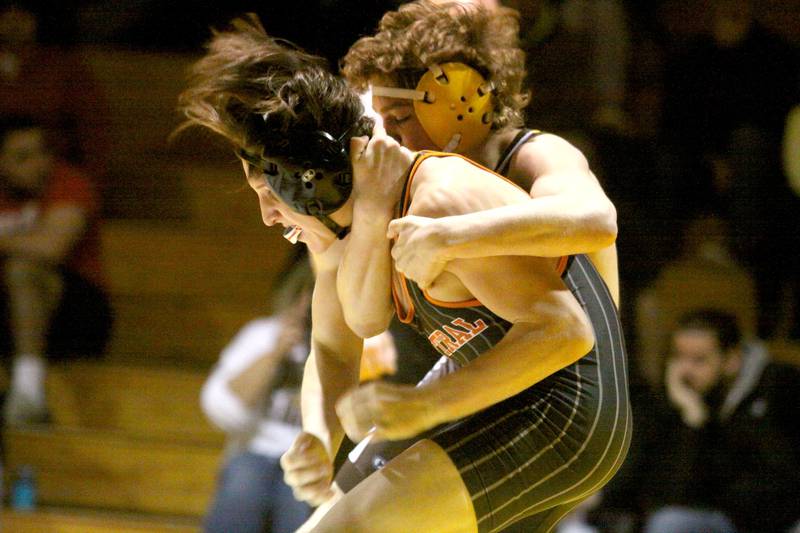 Jacobs’ James Wright, back, battles Crystal Lake Central’s Dominic Vitale at 138 pounds in varsity wrestling Thursday at Algonquin.