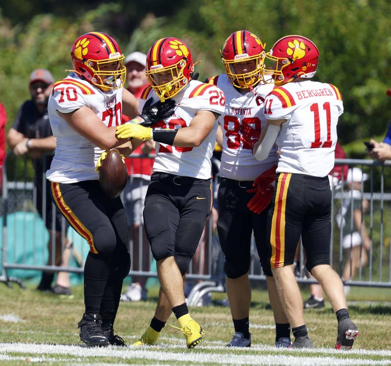 Batavia's Nathan Whitwell (28) is greeted by his teammates Batavia's Mason Popp (70) Brett Berggren (11) and Nate Moorman (82) in the end zone Saturday, Aug. 31, 2024 at Duchon Field in Glen Ellyn.