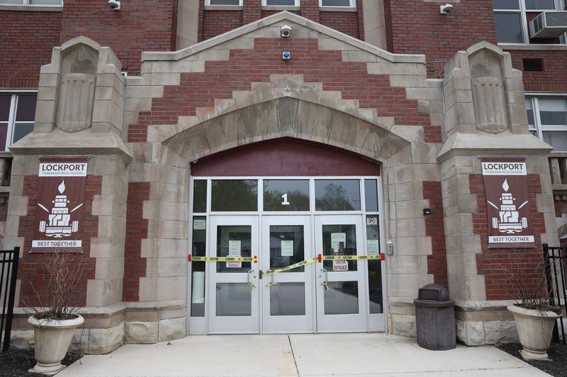 Caution tape is put across the main entrance as work is done at the Lockport Township High School Central Campus on Thursday, April 18, 2024.