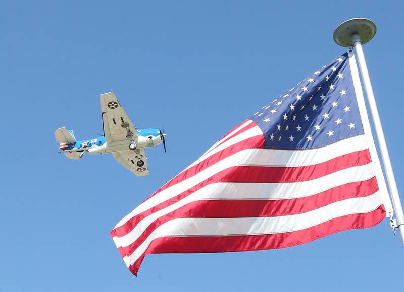 A TBM Avenger aircraft flys over an American Flag during the TBM Reunion and Air Show on Friday, May 17, 2024 in Peru.