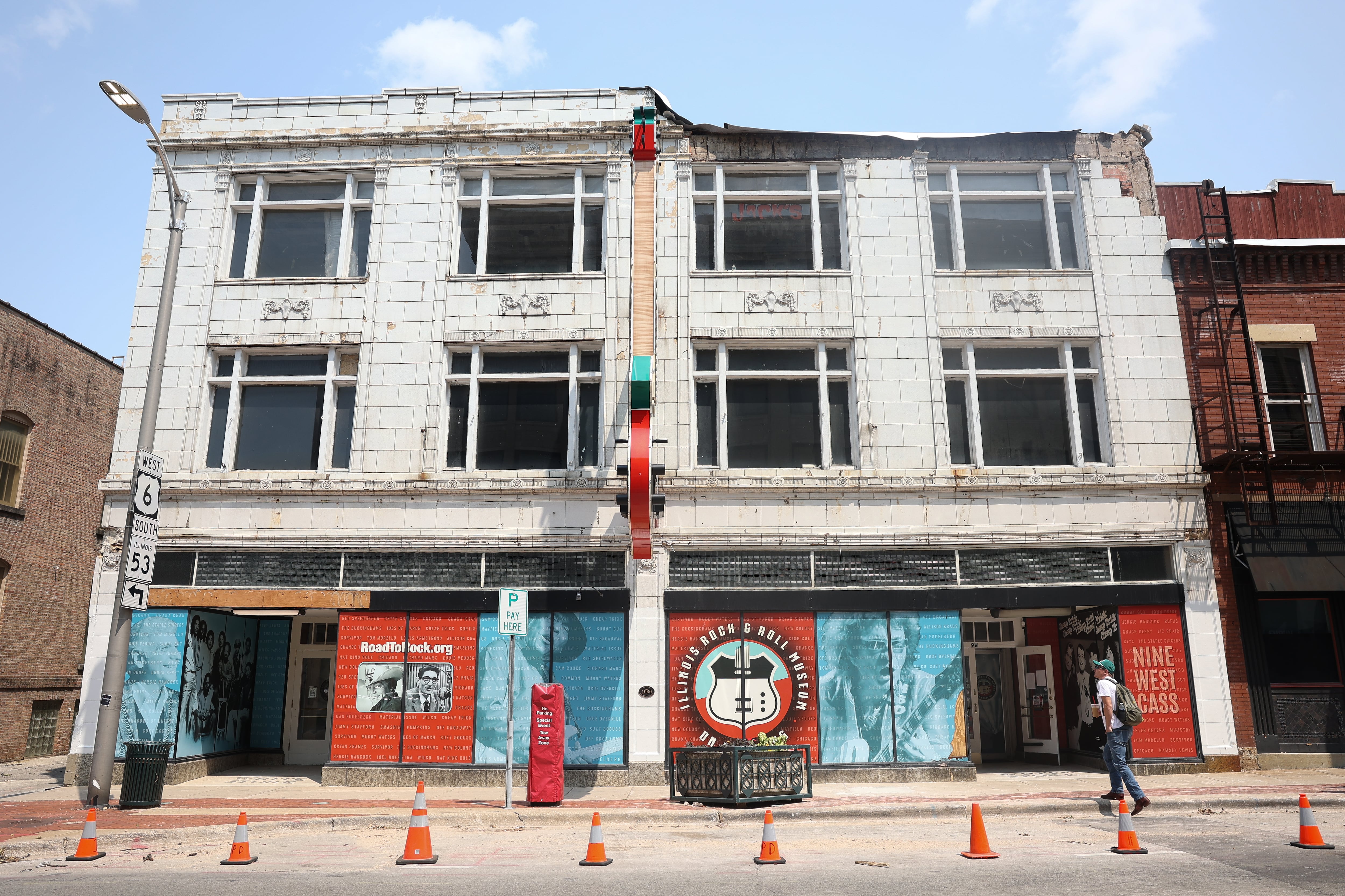 The damaged awning of the Illinois Rock and Roll Museum on Route 66 is removed and safety cones are put out on Tuesday, July 23, 2024 after high winds damaged the building on Sunday July, 14.