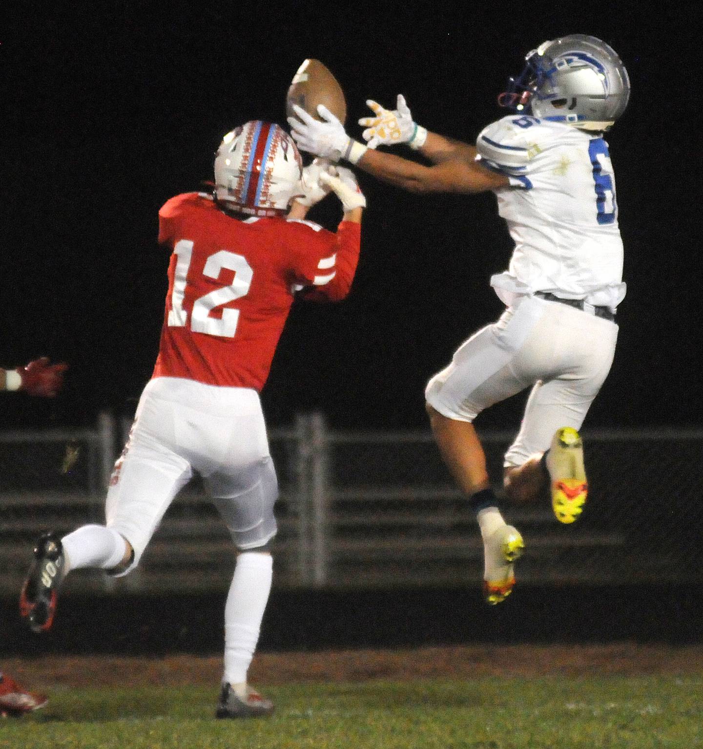 Woodstock's Charles Gilmore (6) makes a catch as Ottawa's Conner Price tries to block at King Field on Friday, Oct. 21, 2022.