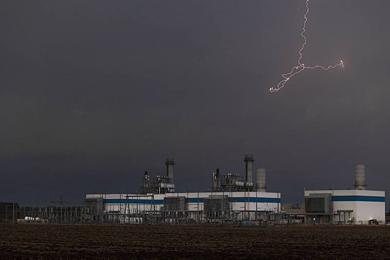 Lightning appears above the Nelson power plant as storms roll through the area Friday, March 31, 2023.