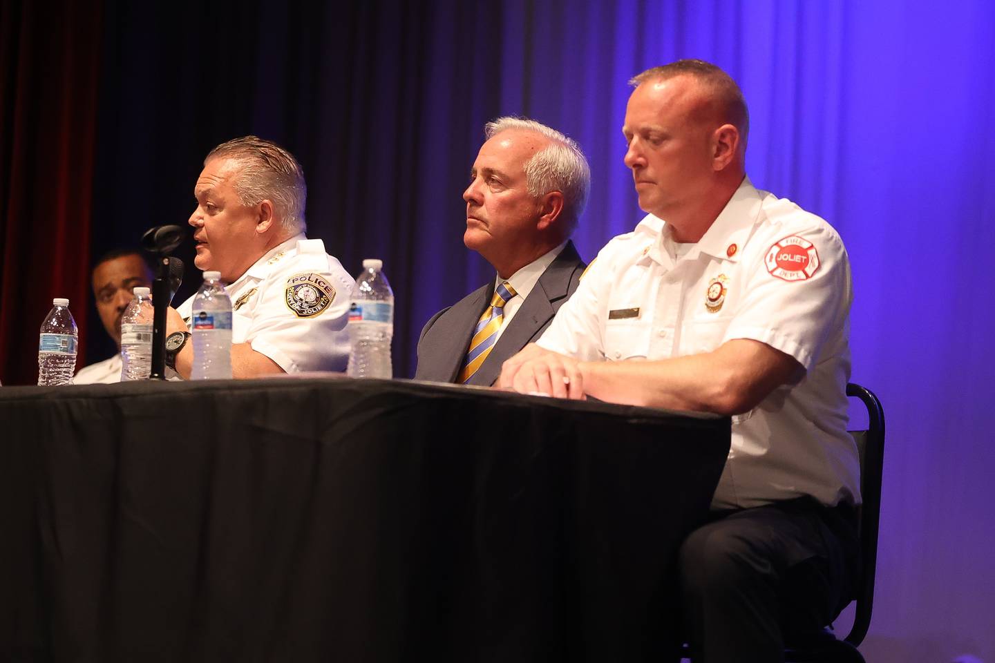 Joliet Police Chief Bill Evans, left, answers a public question as Mayor Terry D’Arcy and Joliet Fire Chief Jeff Carey look on at the Public Safety Open Forum at the Billie Limacher Bicentennial Park Theatre on Wednesday June 26, 2024 in Joliet.