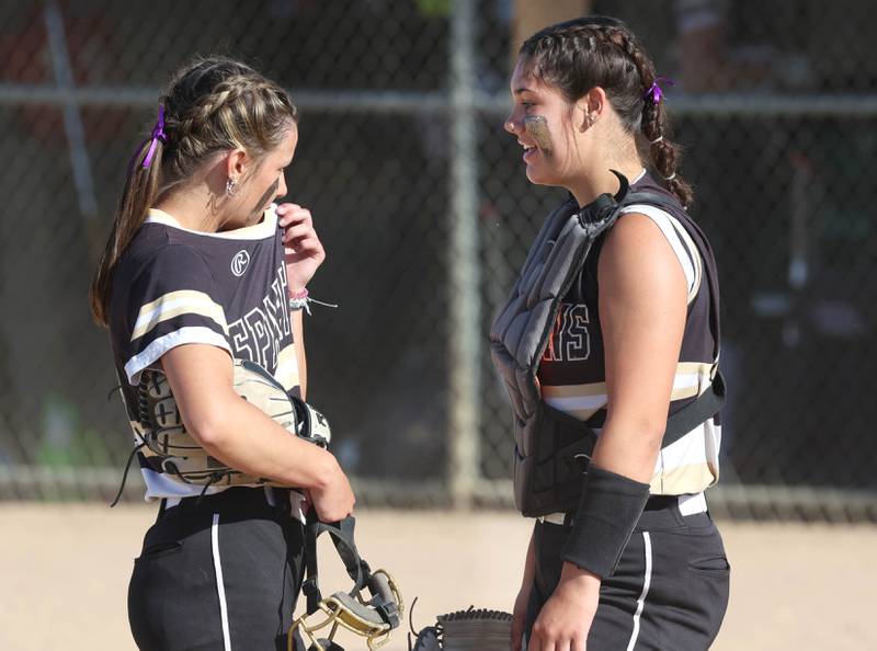 Sycamore catcher Kairi Lantz comes out to talk to pitcher Bella Jacobs during their Class 3A sectional semifinal against Kaneland Thursday, May 30, 2024, at Sycamore High School.
