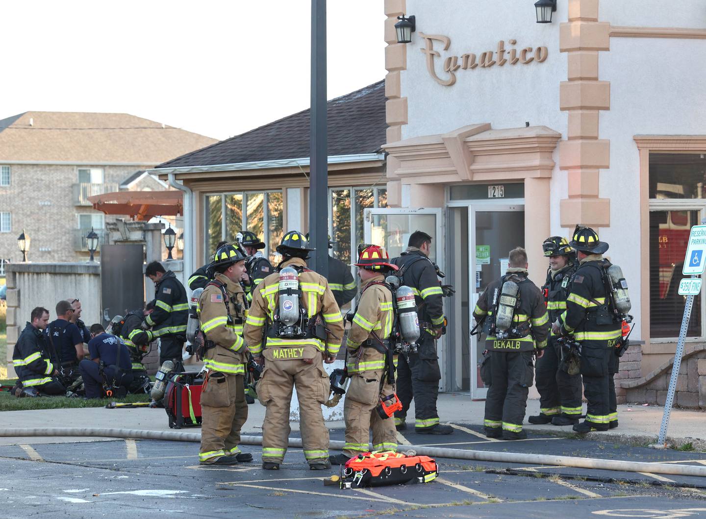 Firefighters gather after battling a structure fire Friday, Sept. 1, 2023, in the building that once housed Fanatico Italian restaurant at 1215 Blackhawk Road in DeKalb.