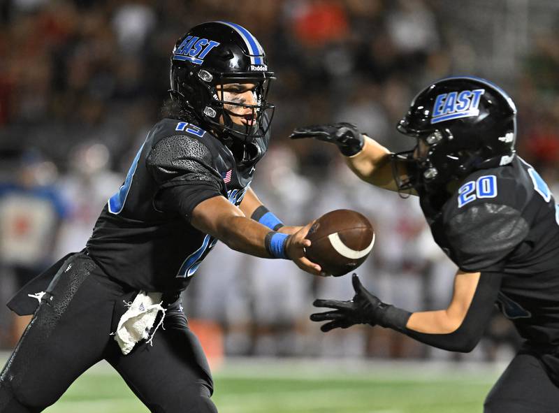 Lincoln-Way East's Jonas Williams hands the ball off to Brody Gish during a non-conference game against Maine South on Friday, Aug. 30, 2024, at Frankfort. (Dean Reid for Shaw Local News Network)