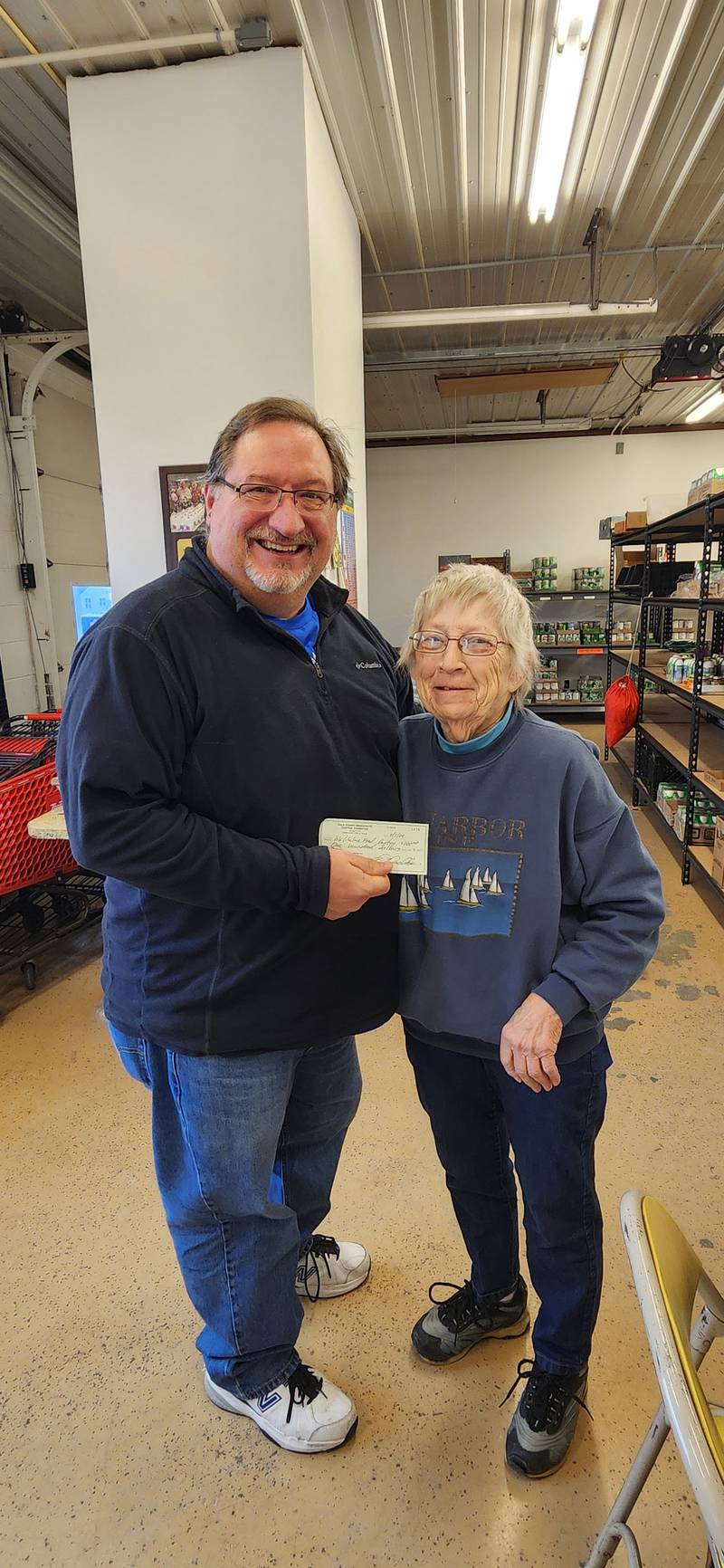 Ogle County Democratic Committee member David “Skip” Donald delivers a donation to Darlene Shafer, treasurer of the Polo Lifeline Food Pantry.