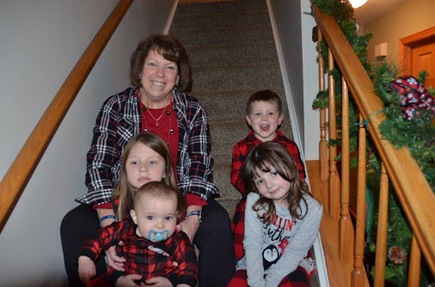 After overcoming battles with breast cancer and heart failure, labor and delivery nurse Nancy Polizzi of Montgomery is grateful for being given new life so that she can continue to bring new life into the world. Here she is surrounded by her grandchildren.