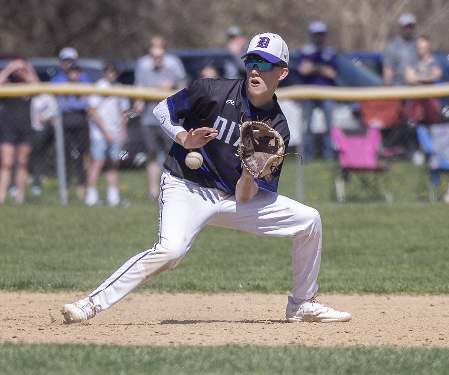 Dixon’s Bryce Feit plays the ball at shortstop against Newman Saturday, April 13, 2024 at Veterans Memorial Park in Dixon.