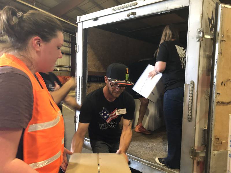 Marissa Rybinski of the McHenry County Department of Health and Chris Benedik of Veterans Path to Hope load a trailer with supplies at Operation Dropbox June 11, 2024.