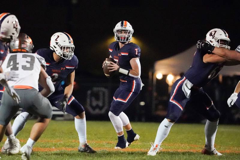 Oswego’s Brett Connolly (7) drops back in the pocket and looks downfield during a football game against Minooka at Oswego High School on Friday, October 18, 2024.