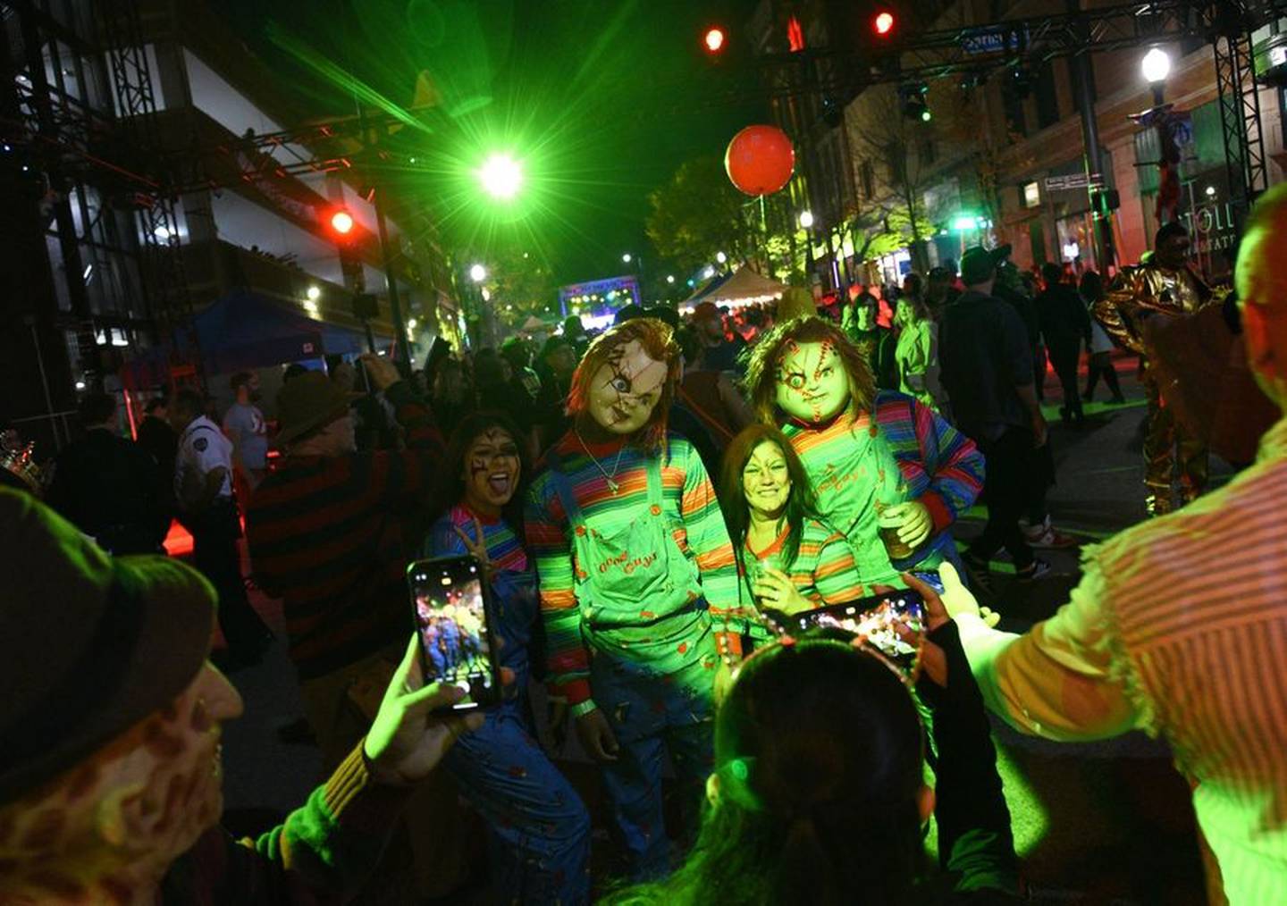 Festival goers take photos of a group of Child's Play fans during Nightmare on Chicago Street in downtown Elgin on Saturday