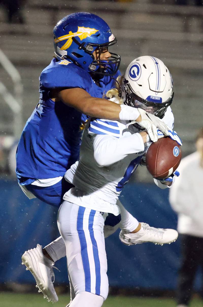 Lake Forest's Nathan Williams (2) tries unsuccessfully to knock away a pass to Geneva's Finnegan Weppner (8) during the IHSA Class 6A playoff game Friday November 3, 2023 in Lake Forest.