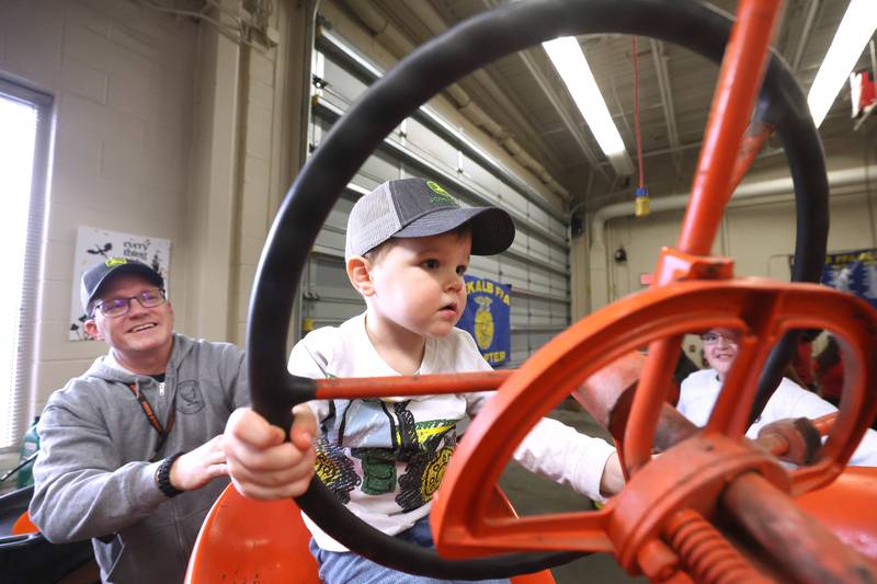 Drew Rouse, 2, from DeKalb, sits on a tractor during the Future Farmers of America Baryard Zoo Wednesday, Feb. 21, 2024, at DeKalb High School. The program, which is held during National FFA Week, gives local kids a chance to visit the high school and learn about the FFA program and animals in agriculture.
